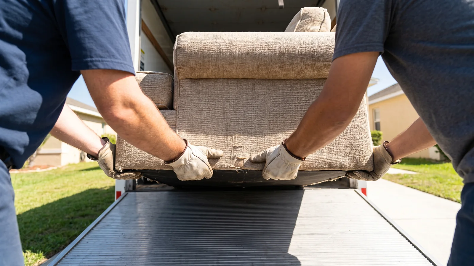 A junk removal crew loading a truck in Costa Mesa, CA